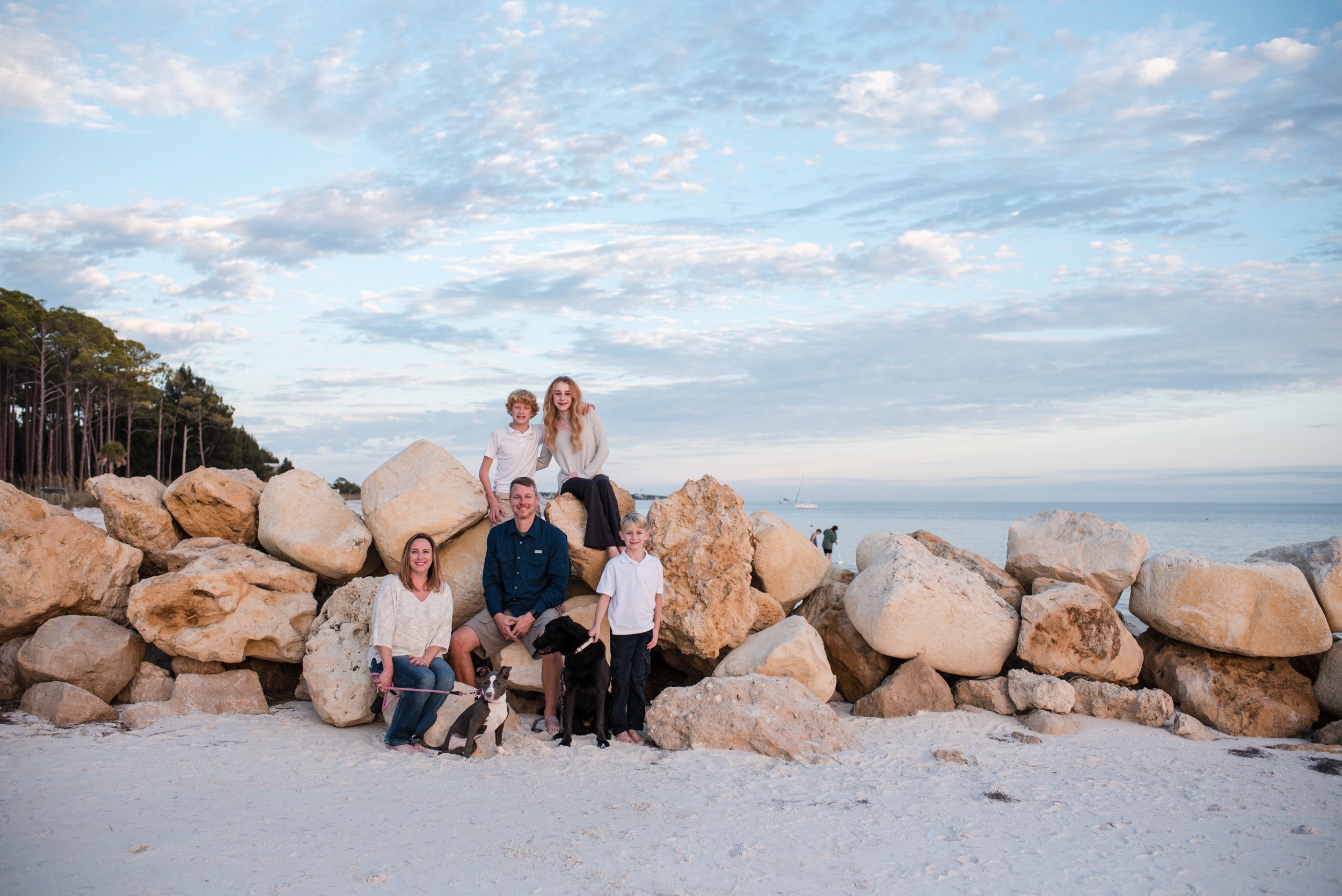 Family enjoys spending time together on the beach at Alligator Point in Florida during sunset.