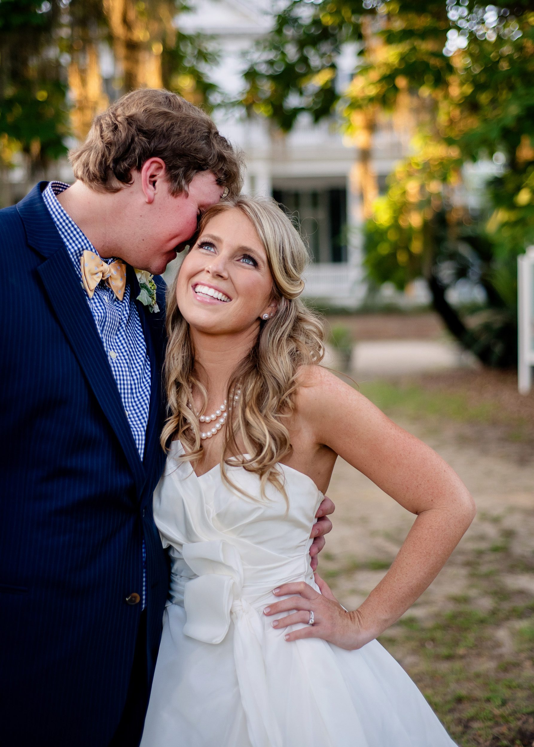Preppy bride and groom cuddle and laugh before their wedding reception at Goodwood in Tallahassee, FL.